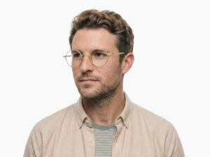Man model wearing Chaplin gold titanium eyeglasses from Vediview