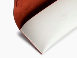 A detail view of an open white leather case from Vediview